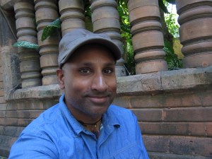 Selfie with terra cotta background.