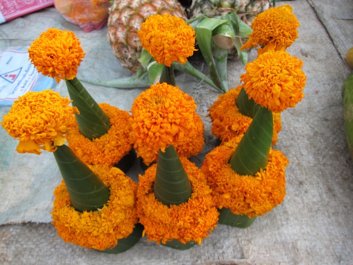 I thought these were plastic. Then I saw the group of women skillfully stitching them together from banana leaves, flowers and dried plant stems.